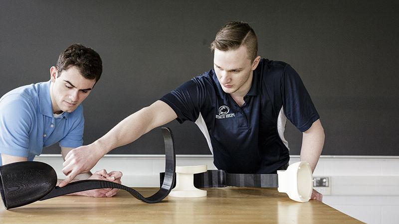 Miller (left) and Bleicher display the leg prosthetic, which was entered in the ASME IAM 3D Challenge.