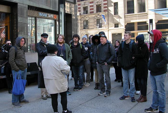 Tom Lynn (pictured fourth from left) and his students listened to a presentation by Beatles expert Susan Ryan (foreground).