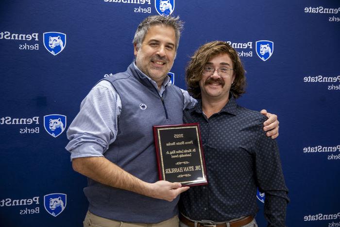 Ryan Hassler is pictured with his award