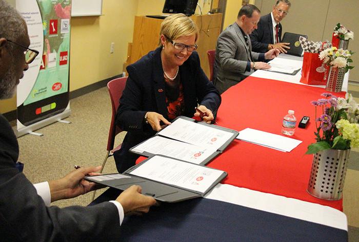 College representatives sign the agreement.