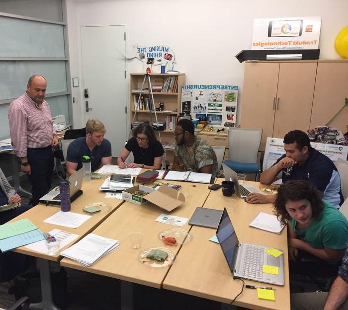 Students working together around a table in the Flemming CEED Center