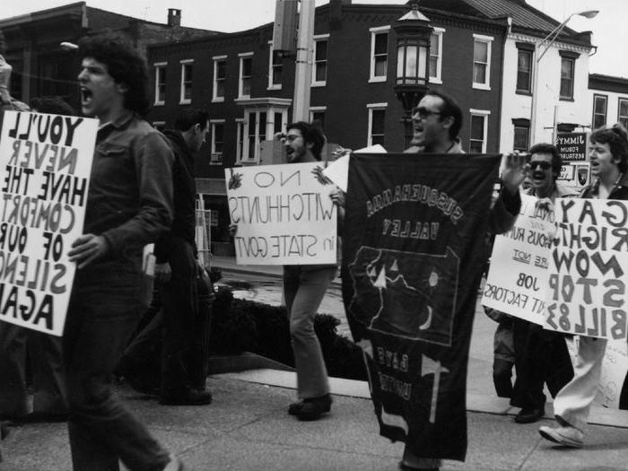 a black and white photo of protesters advocating for LGBTQI+ rights