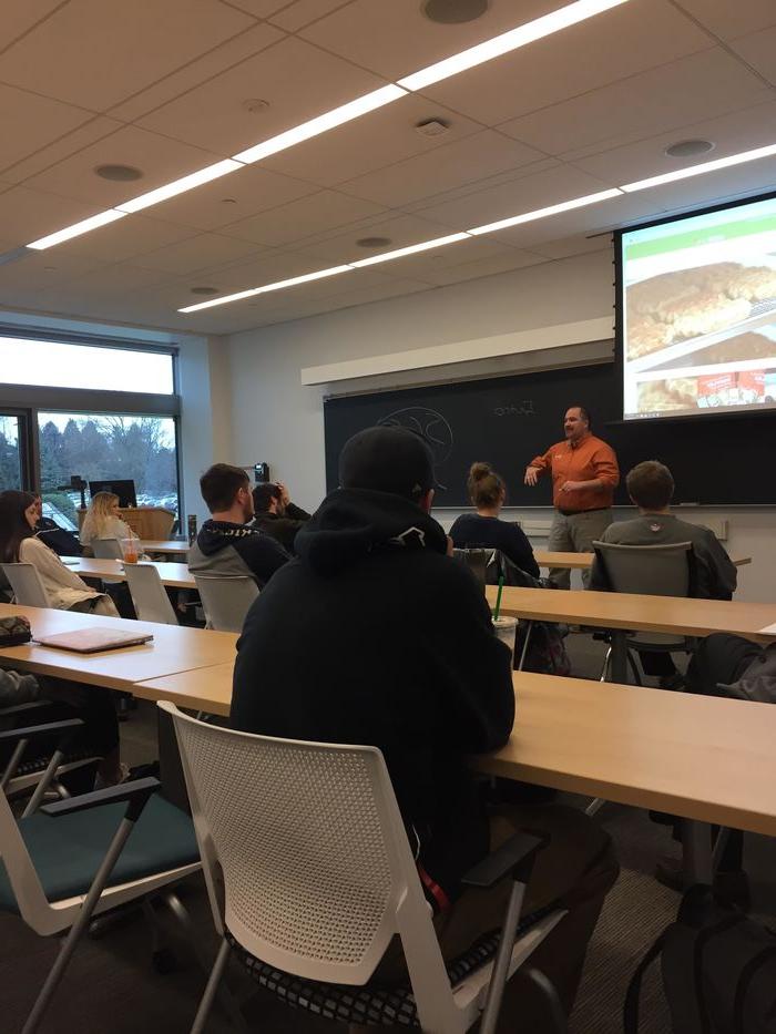Students listen to a presentation by Waffatopia co-owner