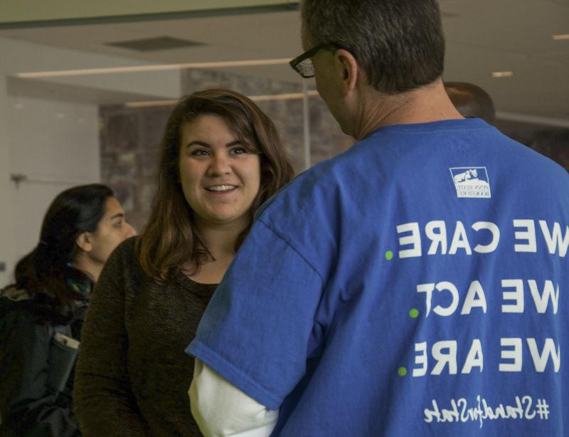 A staff member talking to a student 