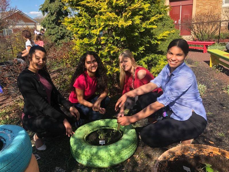 Penn State students help plant with the gardening club at Glenside Elementary