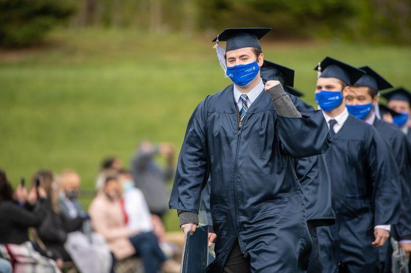 Penn State Behrend graduates celebrate as they leave the stadium at the conclusion of an outdoor ceremony on May 8.