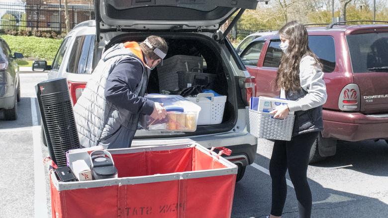 Student packing belongings in car