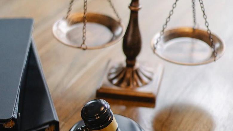 Justice scales, gavel, and books.