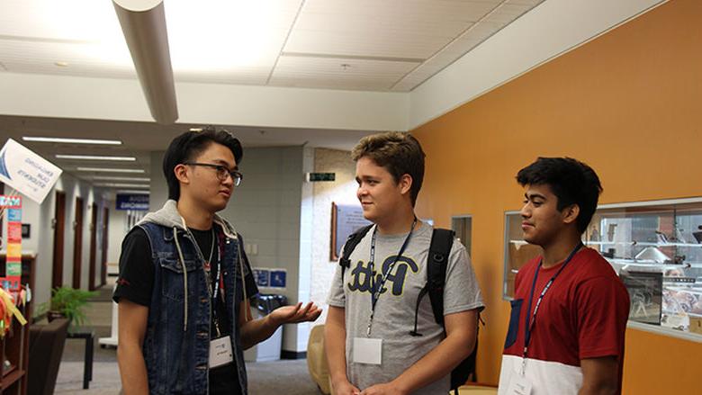 Kevin and a group of International students in the library