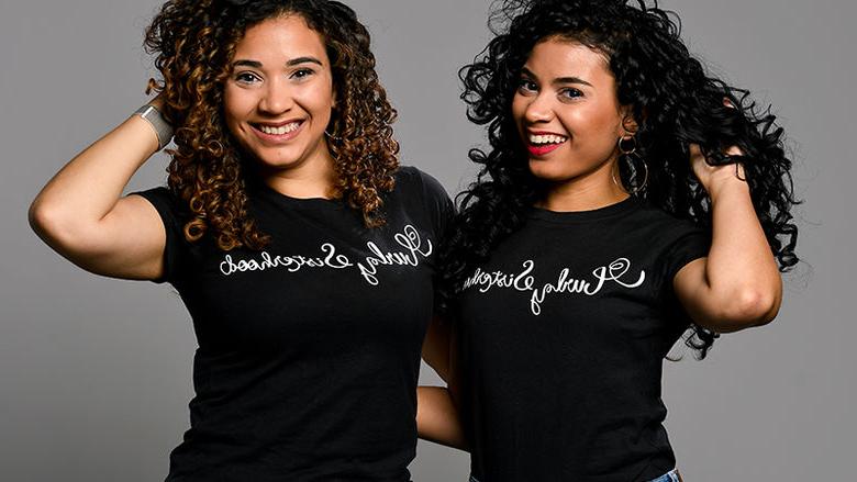 The Varona Sisters pose with their Curly Sisterhood t-shirts.