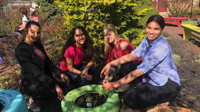 Penn State students help plant with the gardening club at Glenside Elementary