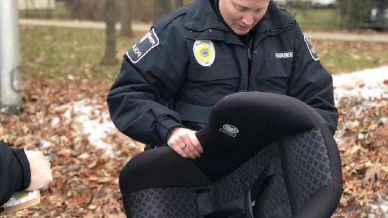 officer inspects child safety seat