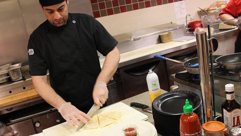 Tully's worker prepares an order at the quesadilla bar