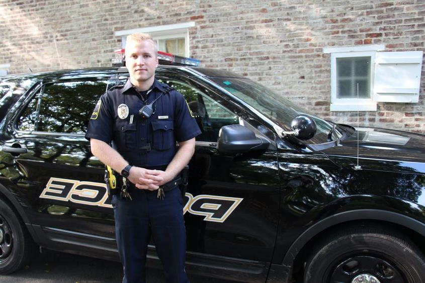 University Police Officer Luke Shivery next to patrol car