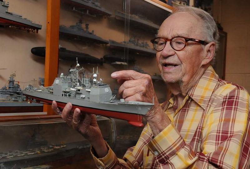 Ed Wiswesser is pictured with a model train.