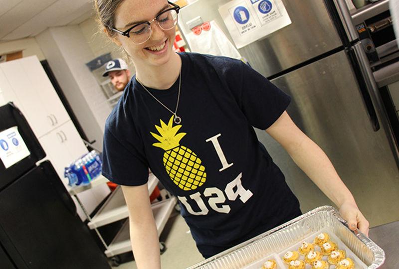 Student preparing food at Opportunity House