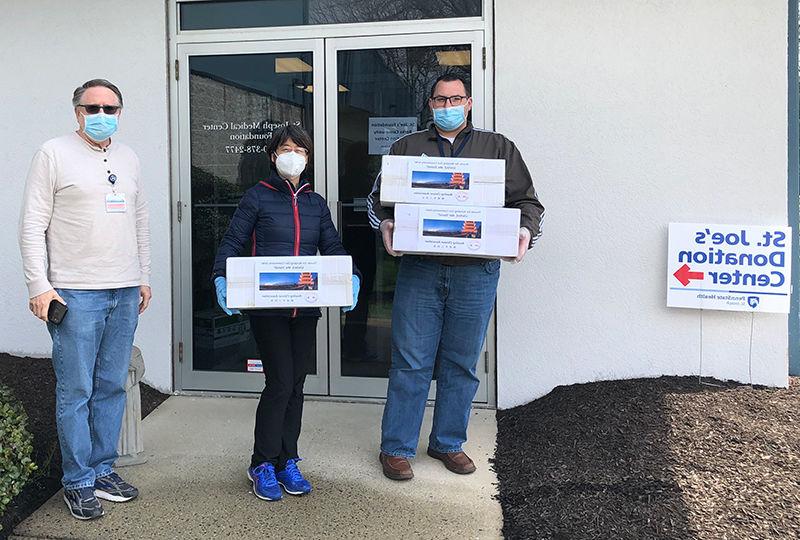 Hongyan “Red” Yuan delivers 1,200 surgical masks to Penn State Health St. Joseph.