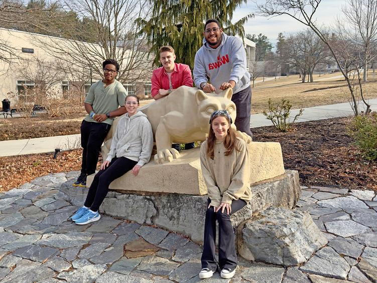 Berks student members of the team are pictured by the Lion Shrine.