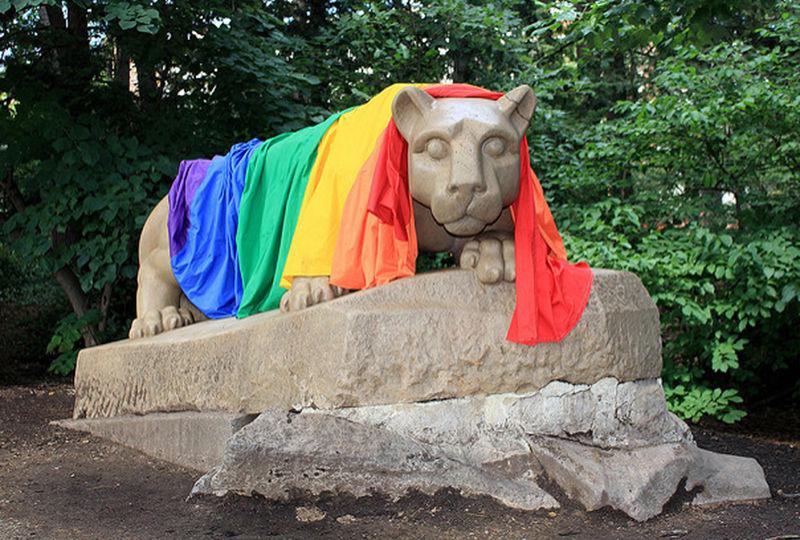 A rainbow pride flag over the Nittany Lion.