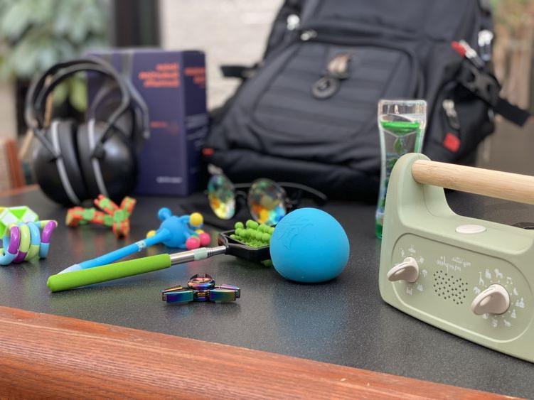 photo of black backpack with sensory tools surrounding it