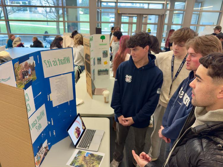 Students looking at a poster display