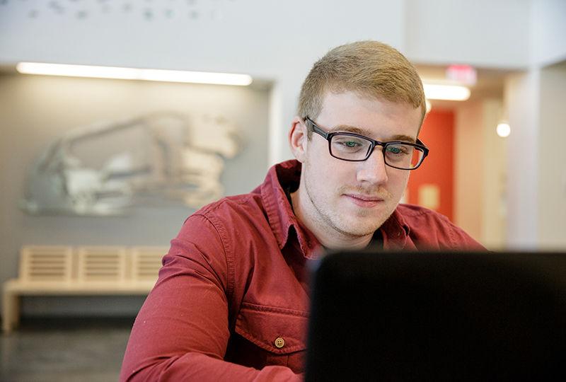 Berks student focusing on his studies in the library. 